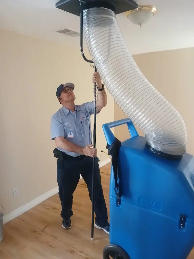 Furnace Tune-Up technician using HEPA equipment in Wendell